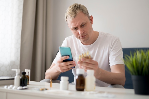 Free Photo man learning about his pills