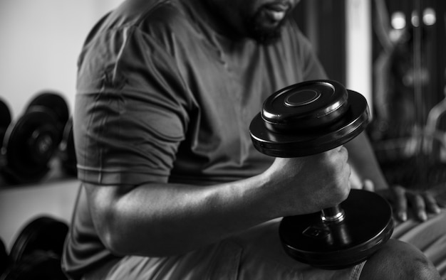 Free Photo man lifting weights at the gym