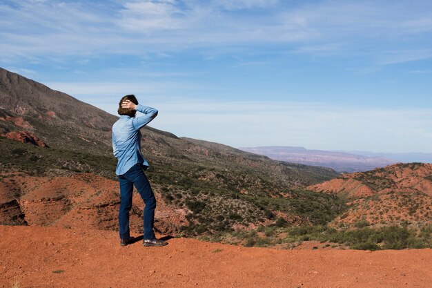 Man looking away at mountain landscape