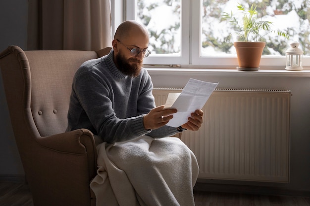 Free photo man looking at bill during energy crisis