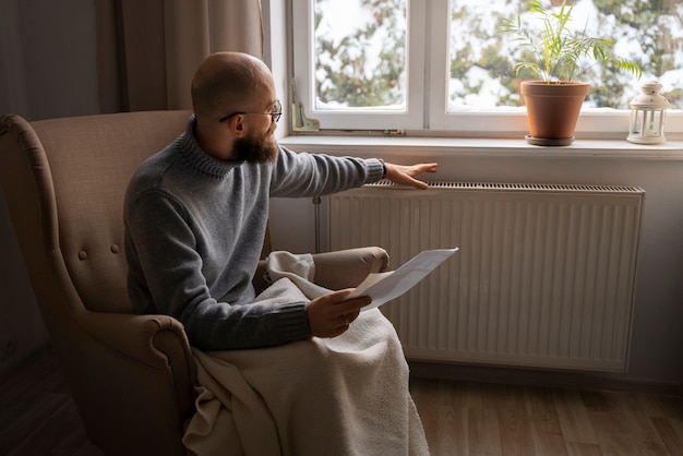 Free photo man looking bill during energy crisis