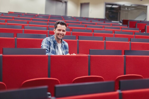 Man looking at camera at lecture hall