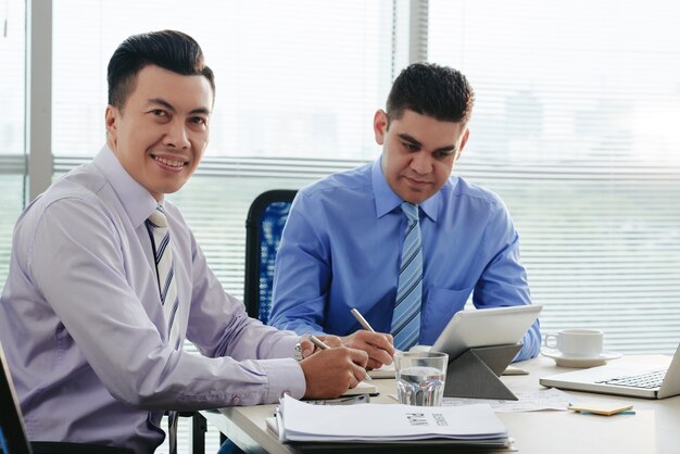 Man looking at camera sitting at the legal consultation