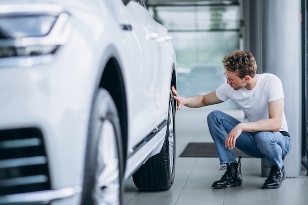 Man looking for a car in a car showroom