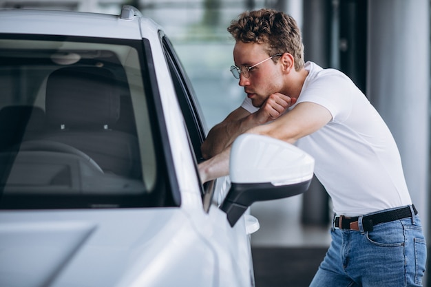 Man looking for a car in a car showroom