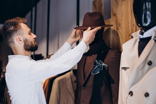 Man looking for hat at mens store