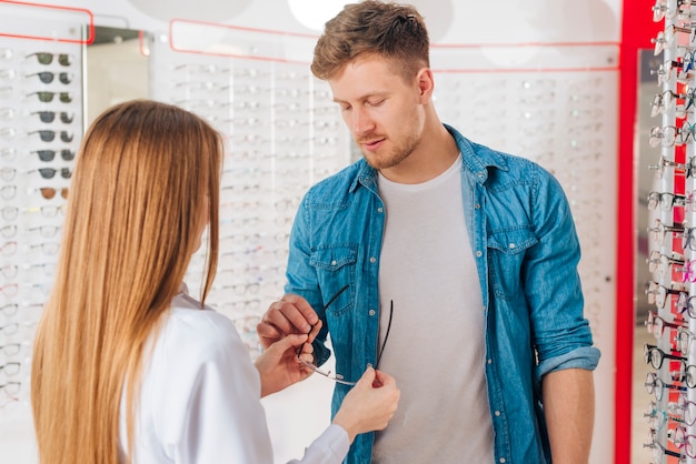 Man looking for new glasses at optometrist