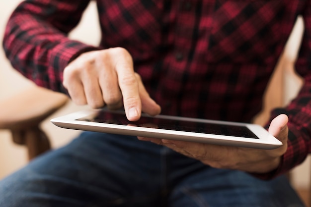 Man looking on a tablet close-up