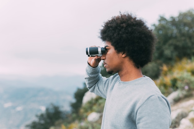 Free Photo man looking through binoculars