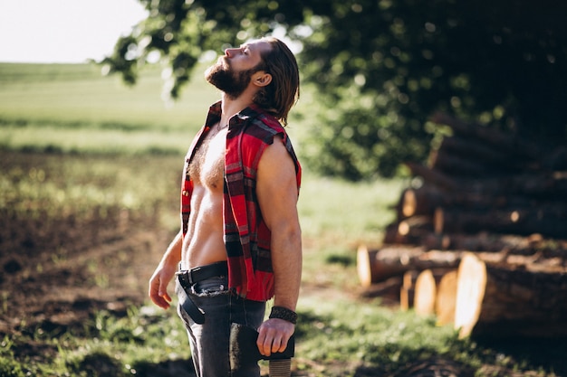 Free photo man lumberjack in forest