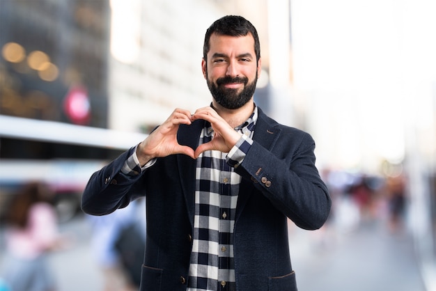 Man making a heart with his hands