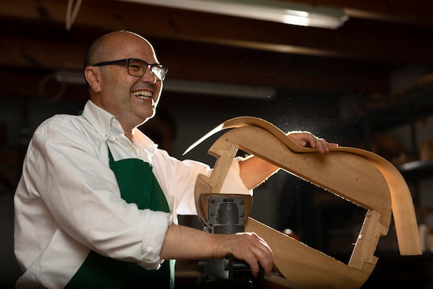 Free photo man making instruments in his workshop