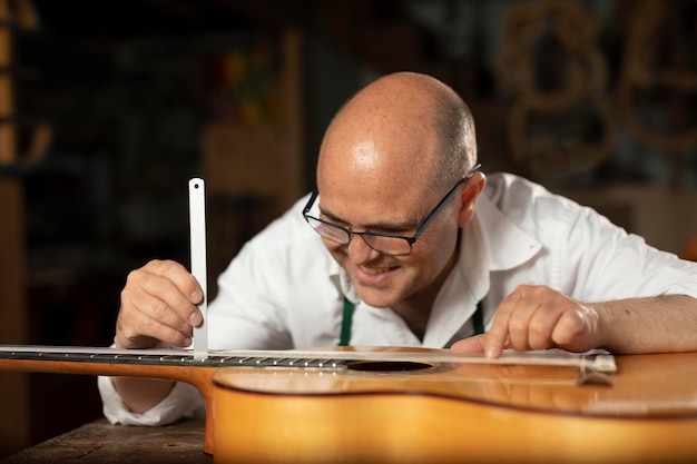 Free Photo man making instruments in his workshop