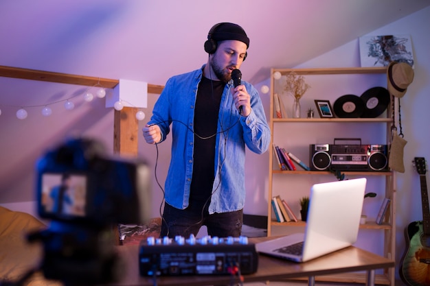 Man making music in bedroom front view