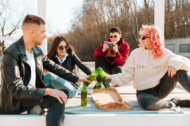 Man making photo of friends on picnic