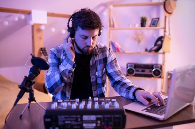 Free photo man making pop music in bedroom medium shot