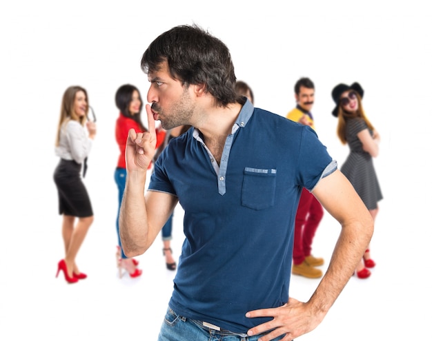 Man making silence gesture over isolated white background