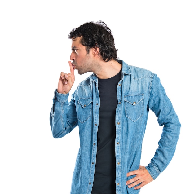 Man making silence gesture over isolated white background