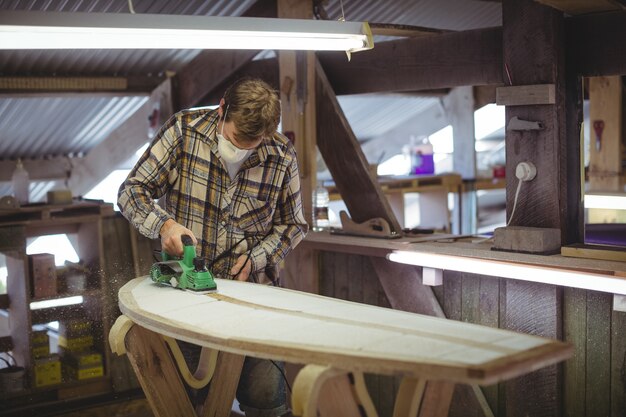 Man making surfboard