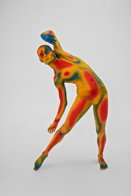 Free Photo man model posing with colorful body painting