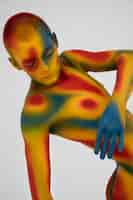 Free photo man model posing with colorful body painting