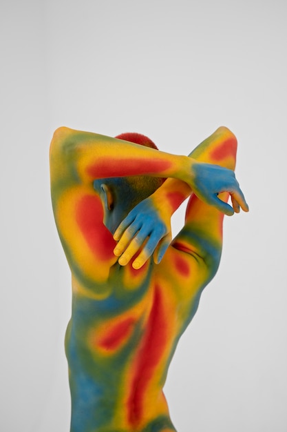 Free Photo man model posing with colorful body painting