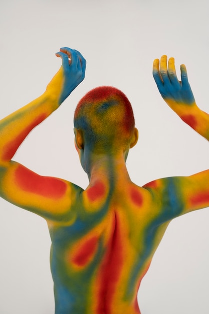 Free Photo man model posing with colorful body painting