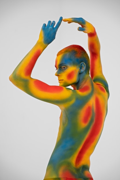 Free Photo man model posing with colorful body painting