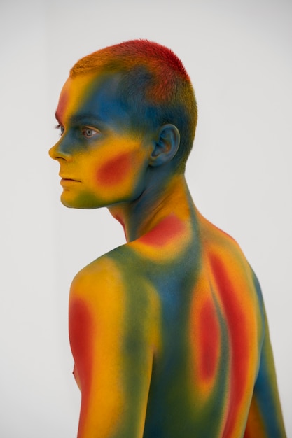 Free Photo man model posing with colorful body painting