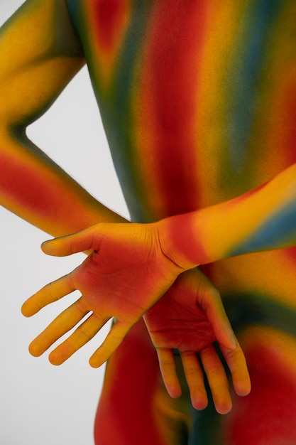 Free Photo man model posing with colorful body painting