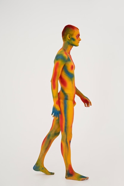 Man model posing with colorful body painting