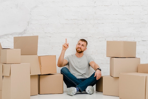 Man near boxes pointing up