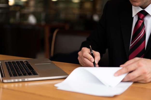 Man in office writing on paper