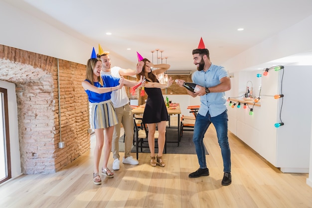 Free photo man opening bottle at party