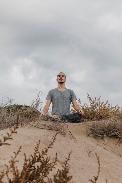 Man outdoors doing yoga