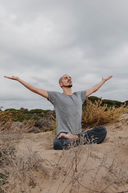 Man outside doing yoga