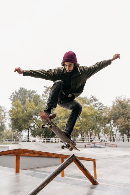 Man outside with skateboard in the city park