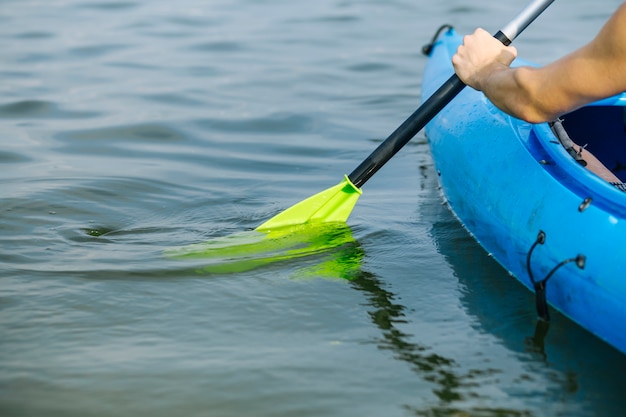 Man paddling a kayak over lake