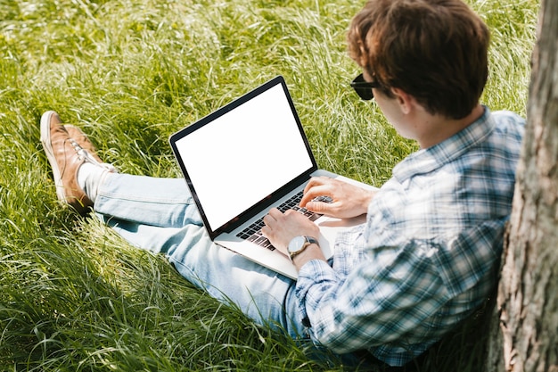 Man in the park working on laptop