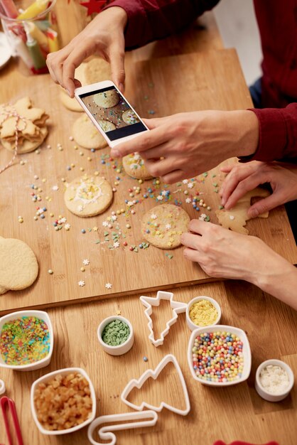 Man photographing his Christmas cookies