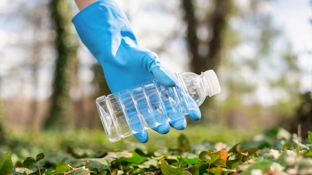 Man at plastic garbage collecting in a polluted park