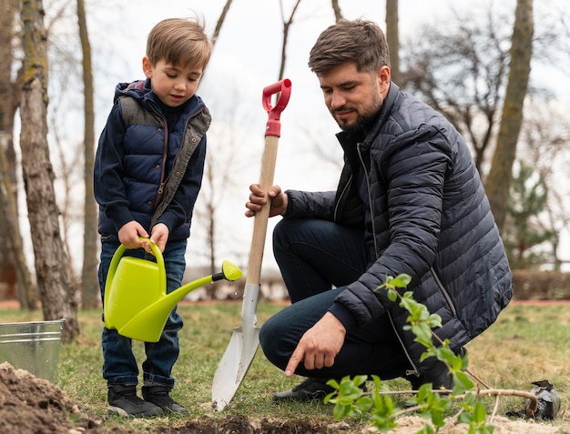 Man plating in the ground a small tree