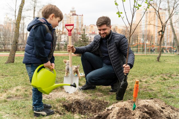 Man plating in the ground a small tree