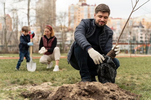 Man plating in the ground a small tree