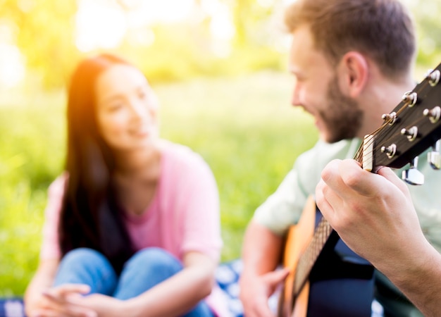 Man playing guitar on picnic