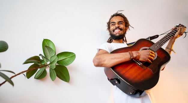 Free Photo man playing the guitar with copy space