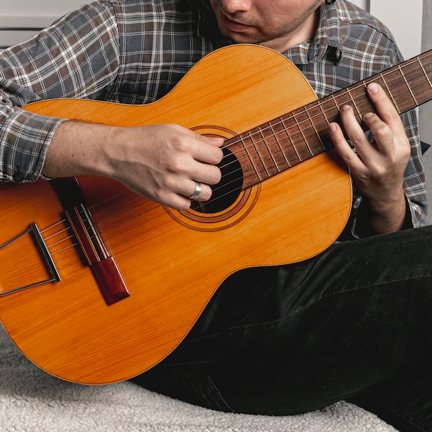 Man playing old acoustic guitar