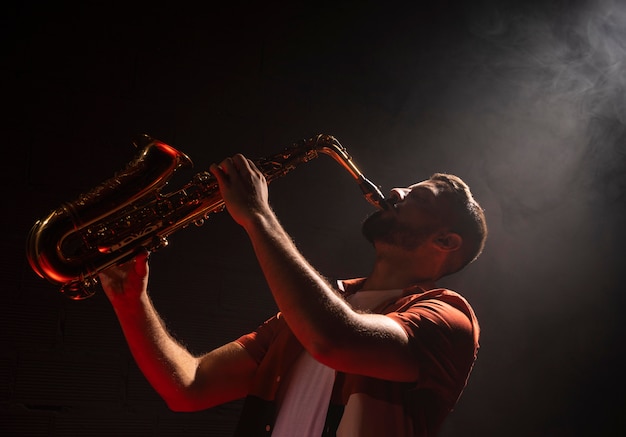 Man playing the saxophone in spotlight