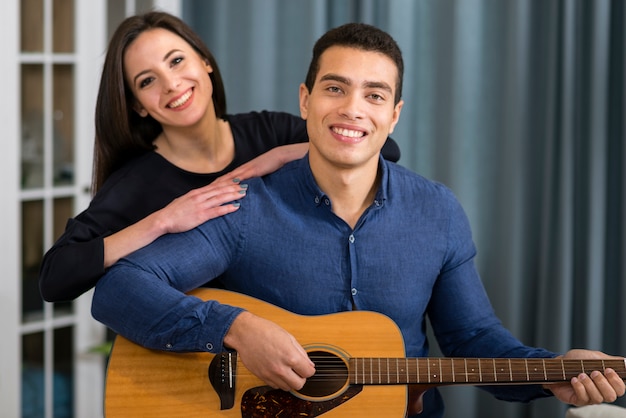 Free photo man playing a song for his girlfriend on valentine's day