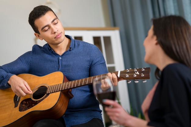 Man playing a song for his girlfriend